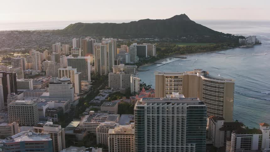 A large coastal city with a mountain in the background