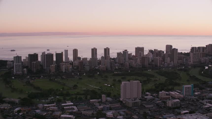 Drone view of a coastal city with tall buildings on the waters edge