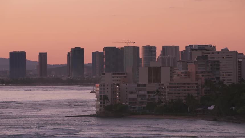 Aerial view of a downtown city on the coast during dusk