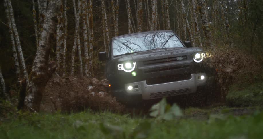 Black suv car drives on dirt track in the forest