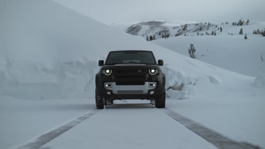 Slow motion view of a car driving through an arctic area