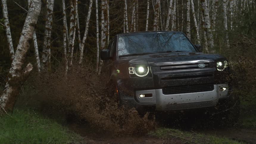 Slow motion view of a car driving through the wilderness