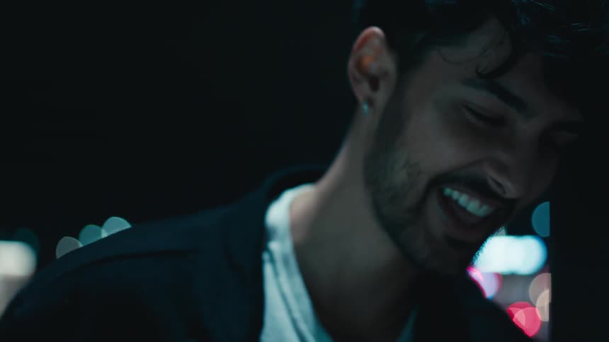 A man laughing as he looks down