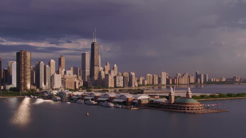 A luxury marina including several buildings with many boats docked