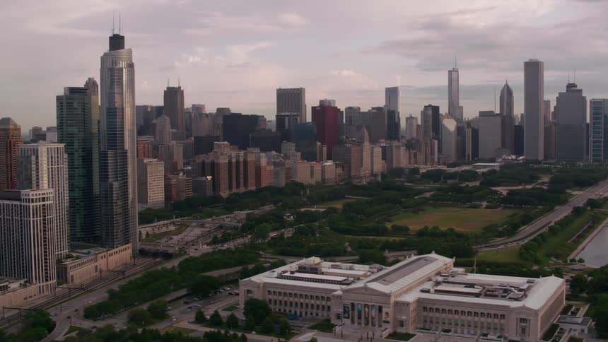 Traffic moves along highways near coast and between city skyscrapers and government building