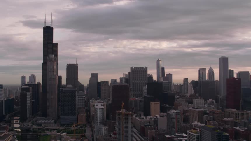 Super tall skyscraper towers over other skyscrapers near large park
