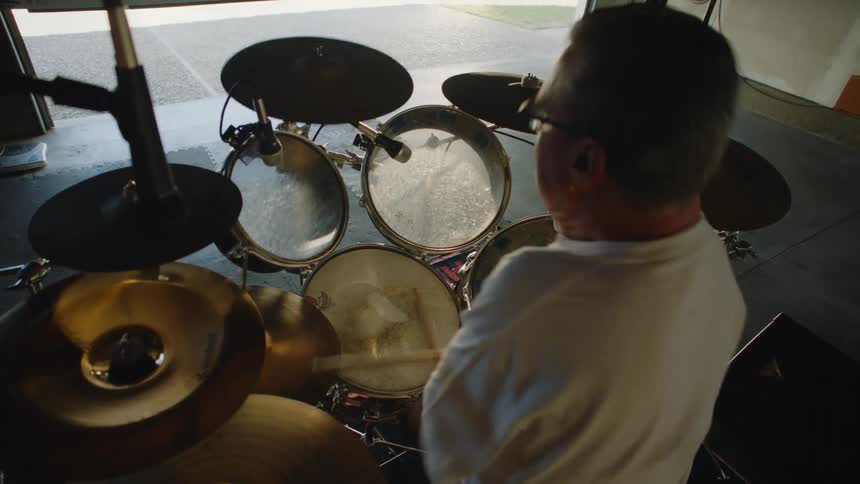 A man playing drums in a room
