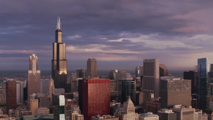 A metropolitan skyline dominated by a large tower