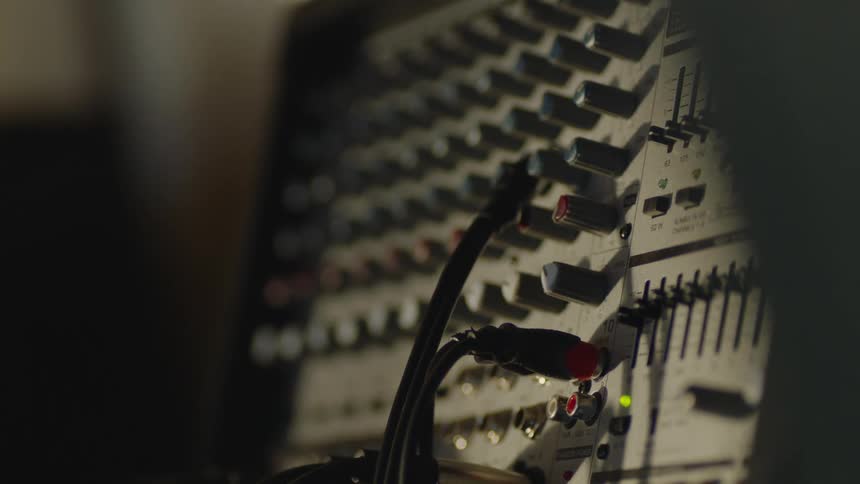 A close up of an electronic system with dials and cords