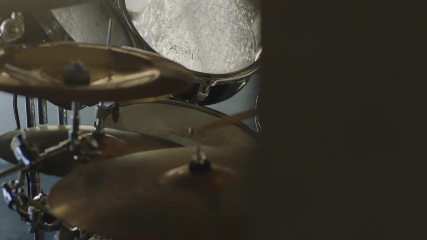 Someone plays the drums slowly