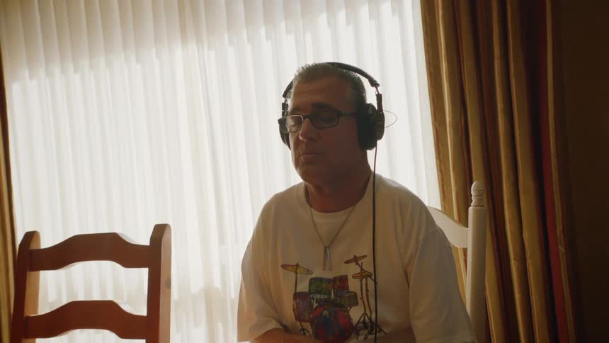 A man is listening to music on his headphones