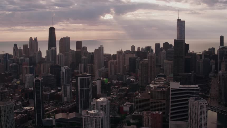 Sunlight shines through breaks in clouds onto city on the coast