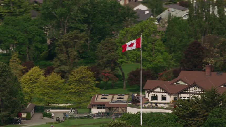 Aerial view of canadian flag flapping in the public park
