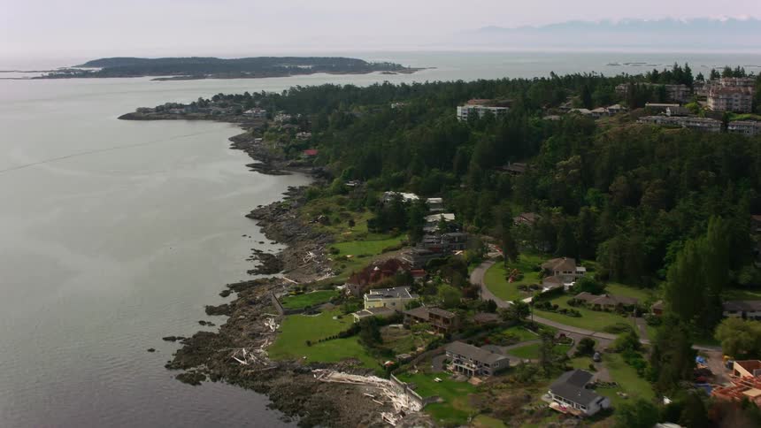Aerial view of houses on the coast of an island close to land at evening