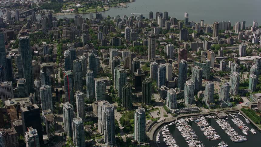 An aerial view of an urban port city on a sunny day