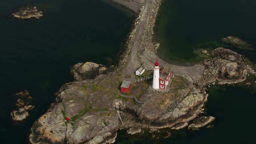 A lighthouse in a peninsula connecting to a forest