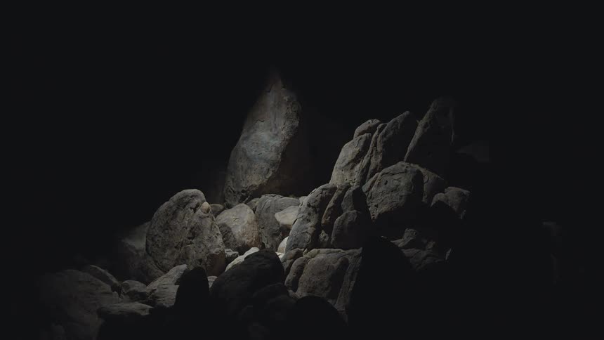 A light shines into the cave search light helicopter drone light
