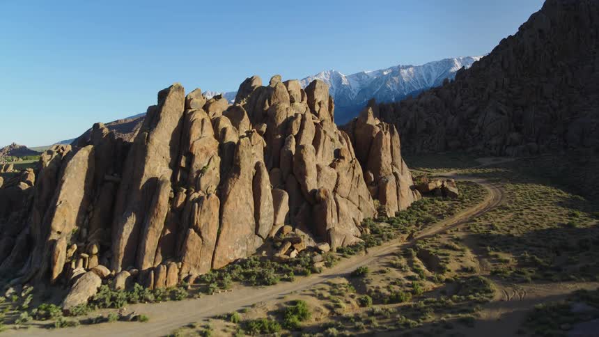 Landscape of rocky hills and distant snowy mountains