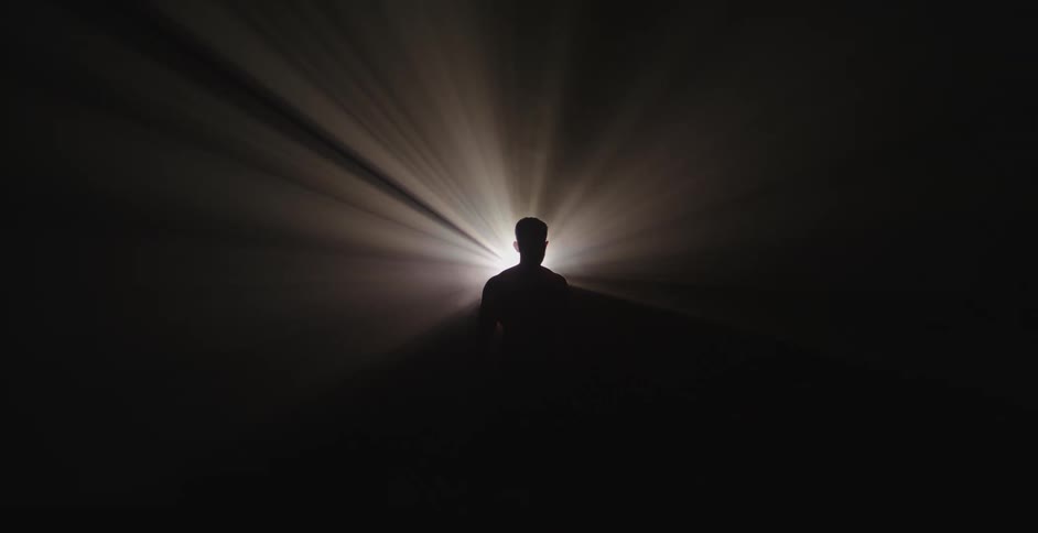 A person stands in front of the light