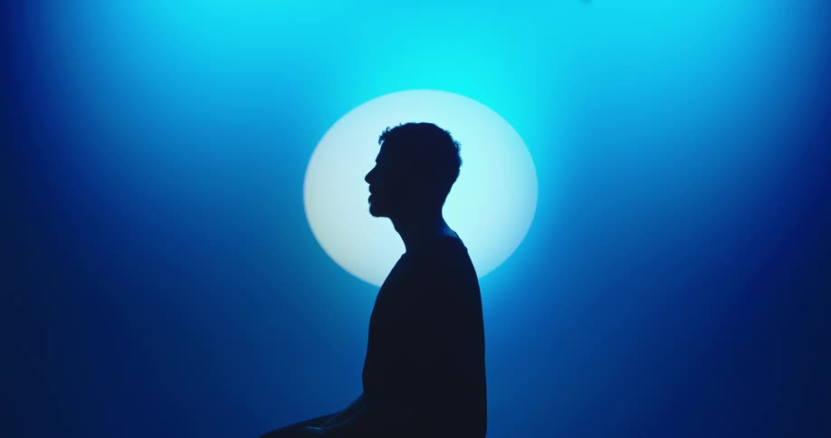 A person is surrounded by blue light