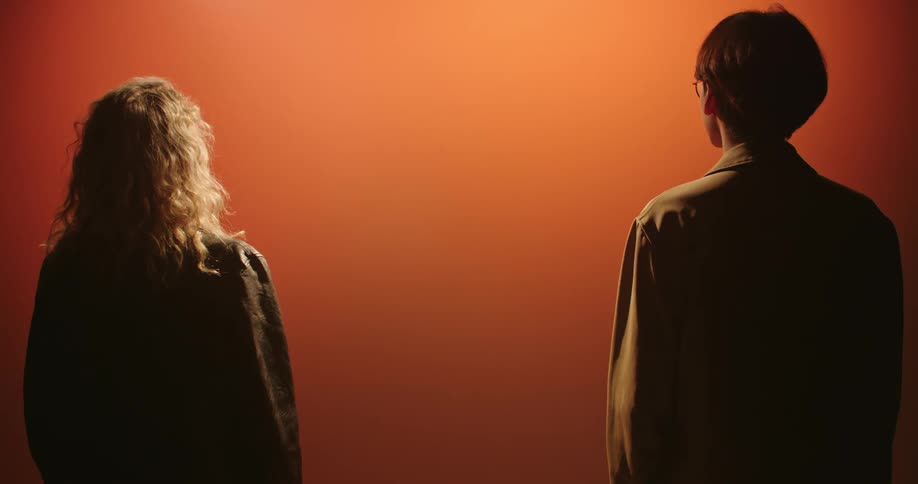 A man and woman stand under the light