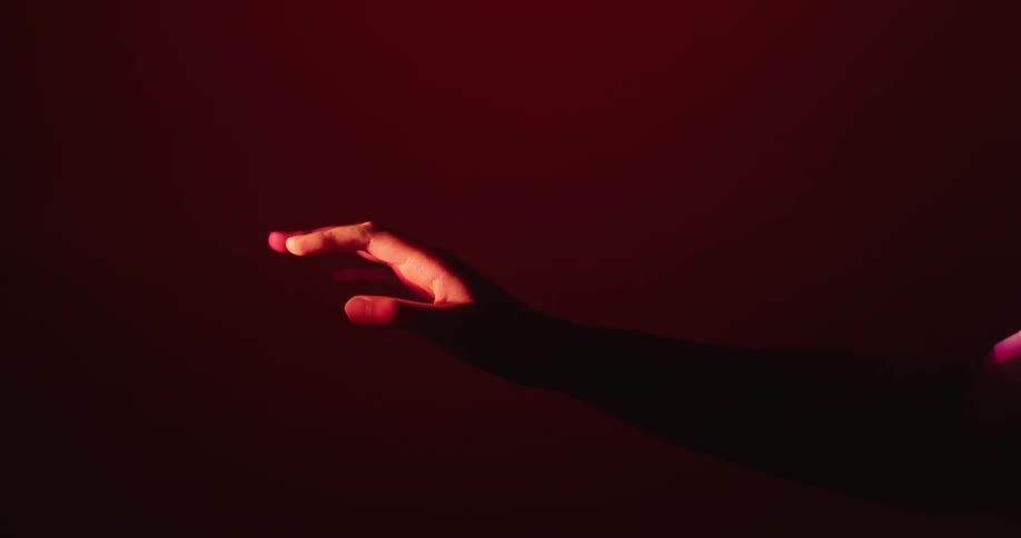 A person moves their hand under the light