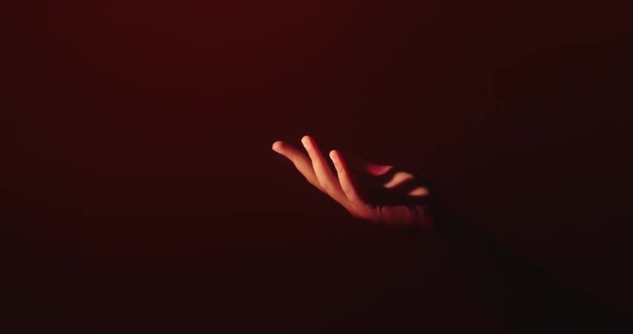 A person moves their hand under the light
