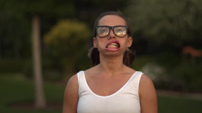 A woman's mouth is being blown open by strong wind in extreme slow motion