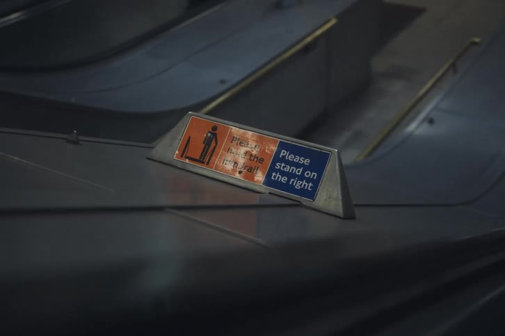 Sign next to escalator provides a warning