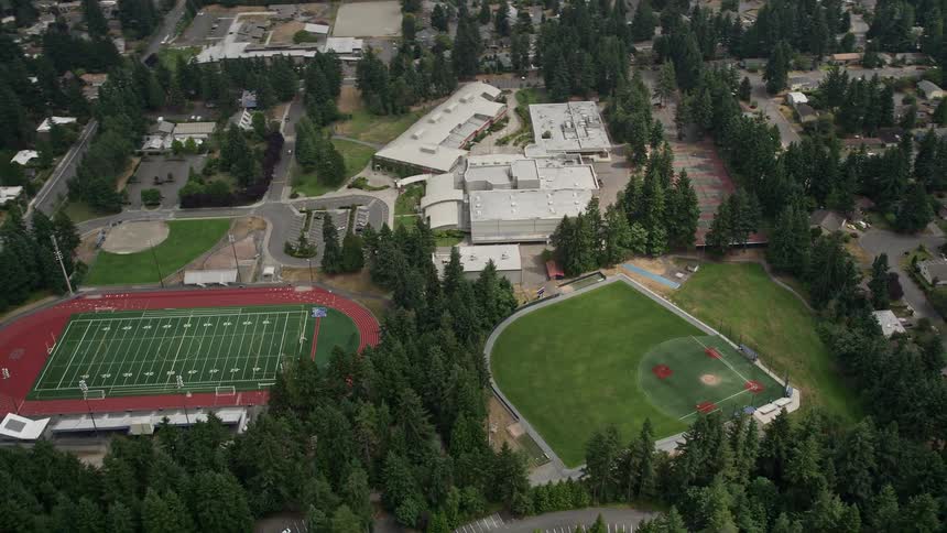 An aerial view of sports fields and Interlake High School in Bellevue Washington showcasing high school athletics and leisure activities on a typical day