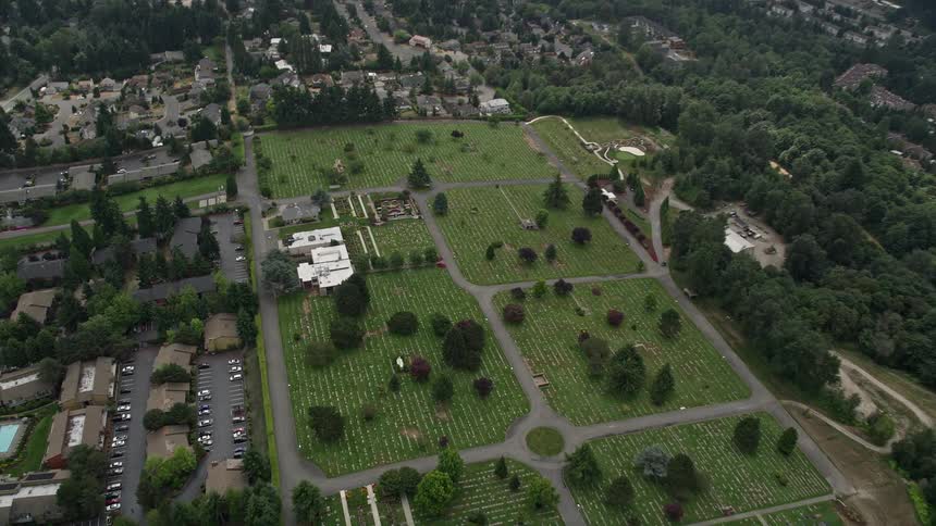 Aerial footage of a cemetery and funeral home in Bellevue Washington shot from a birds eye view with a tilting down effect