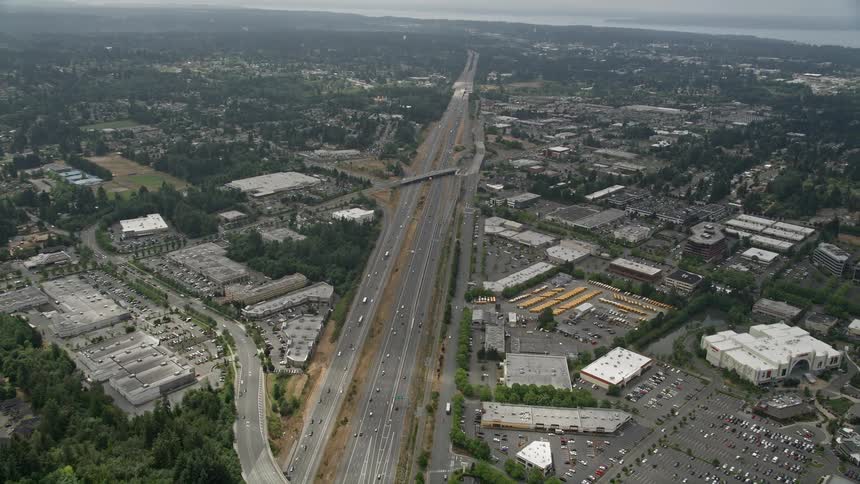 Aerial view of Interstate 5 with light traffic passing by shopping centers in Lynnwood Washington during the day