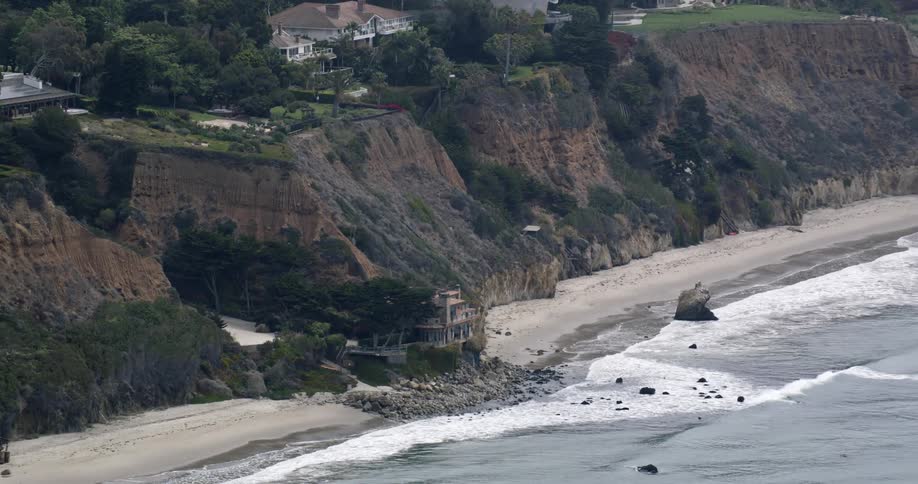 Aerial view of buildings overlooking coastal beach