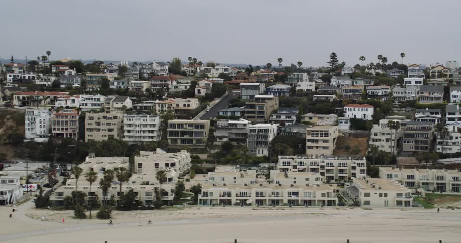 Homes sit on a hill along the beach