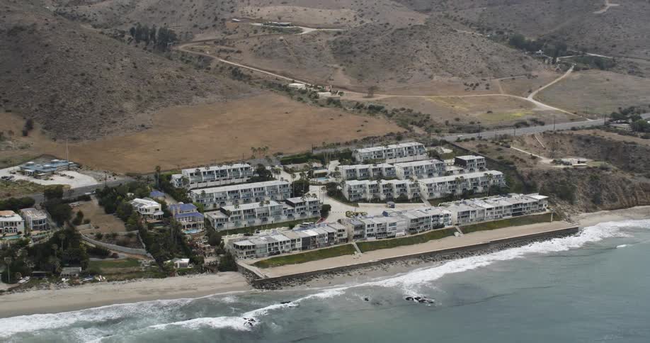 Homes sit on a hill along the beach