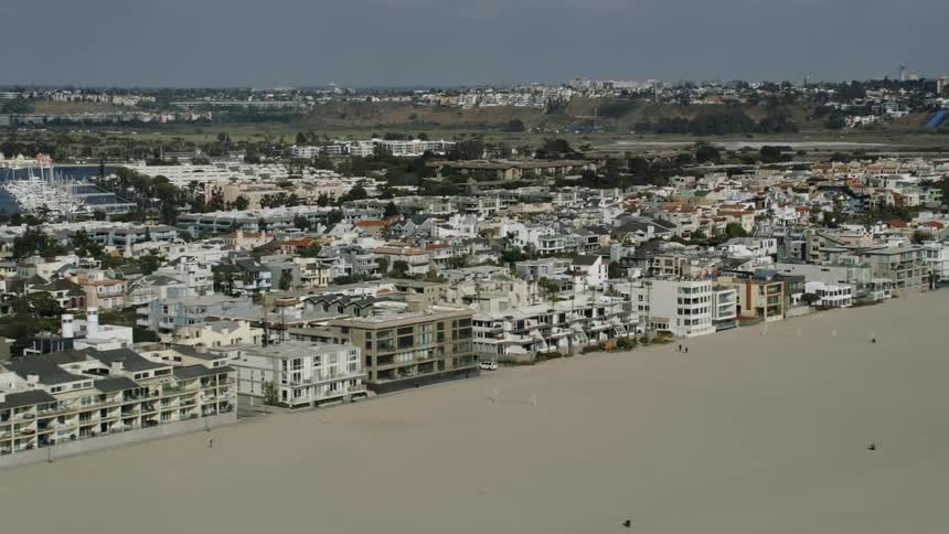 Aerial view of condos on a beach in a waterfront town at daytime
