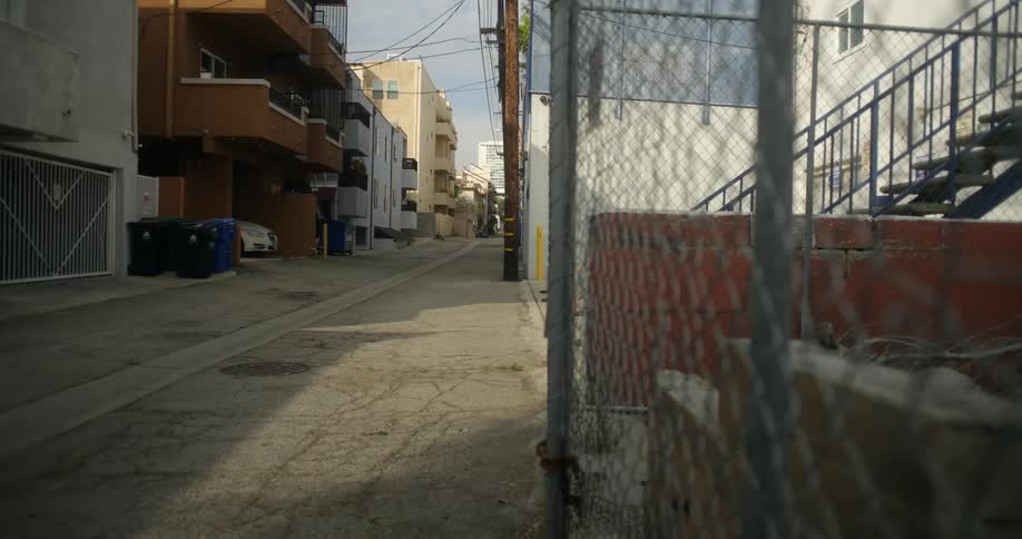 Apartments with balconies overlook a quiet alley