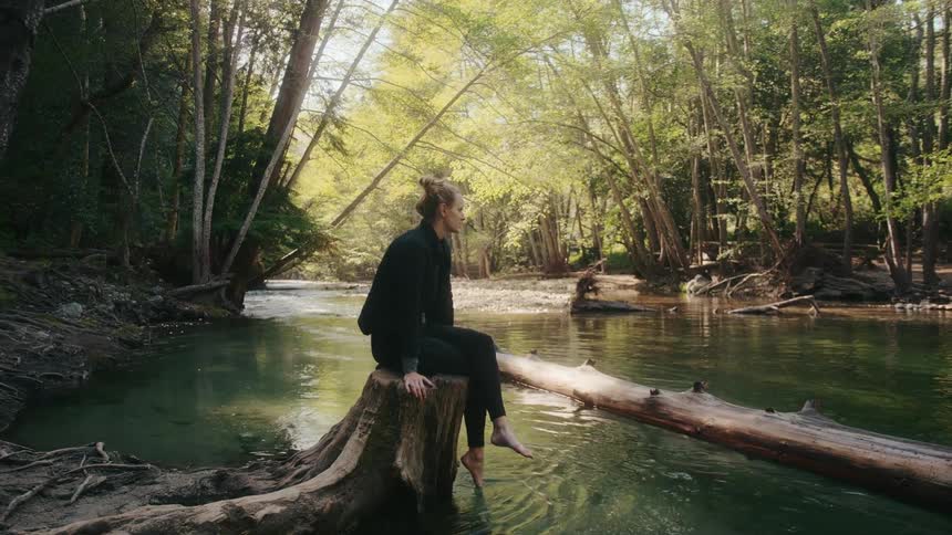 The view is of a young woman that is outdoors in the day time