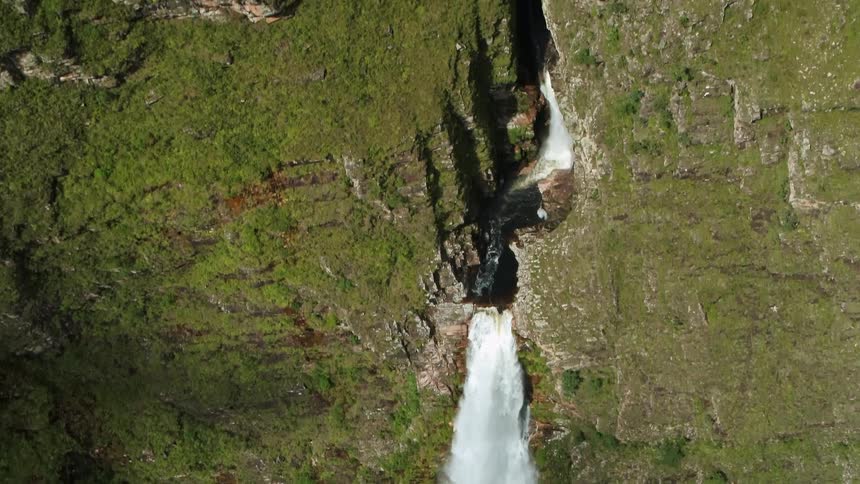 Aerial view of waterfall cascading down the mountainside