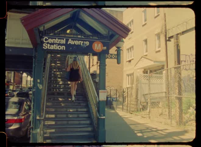 Two people climb the stairs to the train station