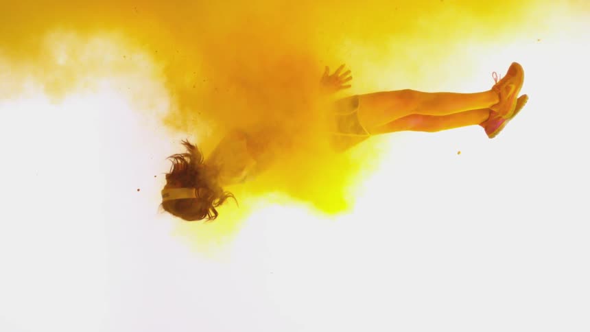 A woman is pulled into a yellow cloud of powder