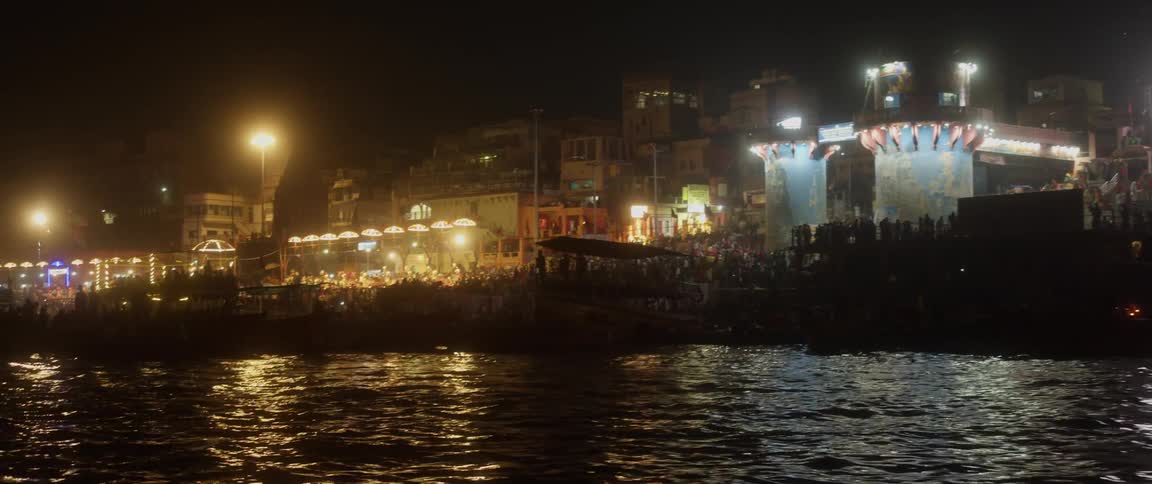 A large crowd attending a party at a pier at night