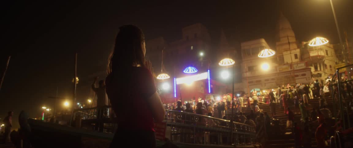 A large crowd gathers outside near a stage