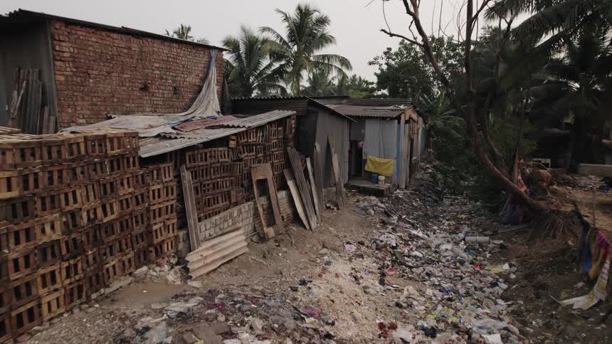 Old and dirty shack near a pile of trash