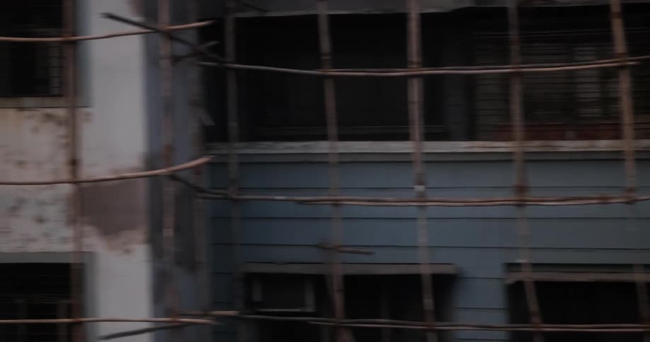 Metal bars crisscross to make barrier around apartment buildings