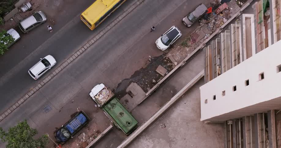 A view from the top of a tall building of the street and parking spaces below