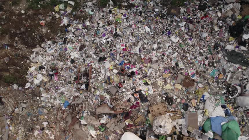 People rummage through piles of trash