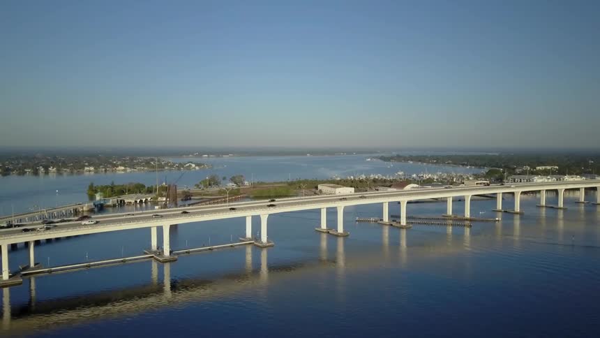 Cars drive along a bridge below