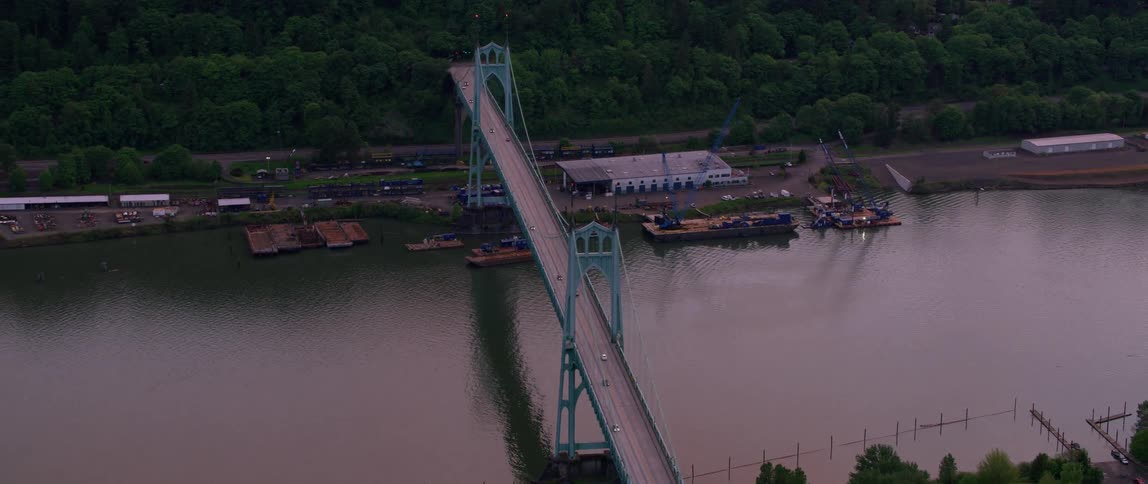 A bridge crossing a river and going over a dock