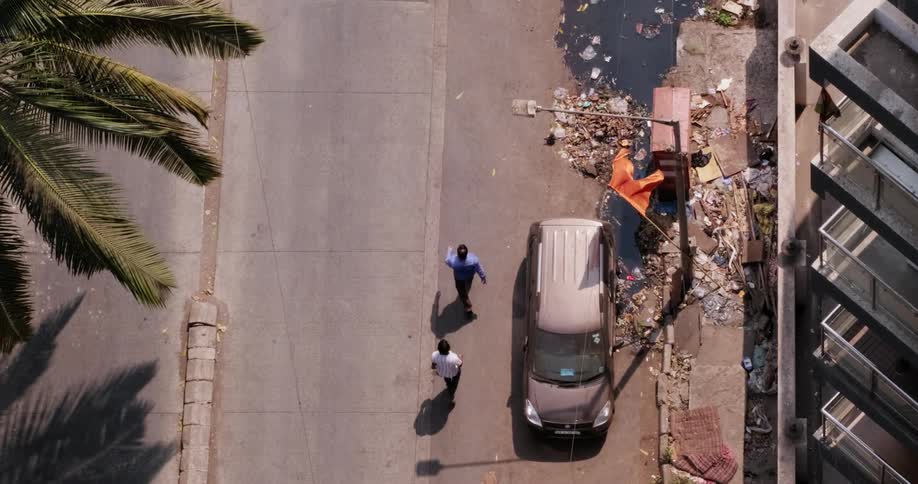 Aerial view of people passing by litter in the street
